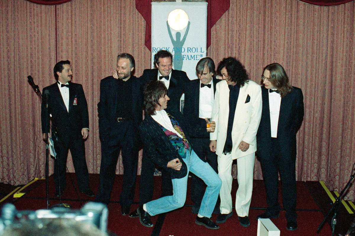 FILE – Jeff Beck plays the air guitar for Jimmy Page, second from right, as unidentified members of the Yardbirds look on at New York’s Waldorf Astoria Hotel, on, Jan. 15, 1992, as the group was on hand for their induction during the Seventh Annual Rock and Roll Hall of Fame Dinner. Beck, a guitar virtuoso who pushed the boundaries of blues, jazz and rock ‘n’ roll, influencing generations of shredders along the way and becoming known as the guitar player’s guitar player, died Tuesday, Jan. 10, 2023, after “suddenly contracting bacterial meningitis,” his representatives said in a statement released Wednesday. He was 78. (AP Photo/Mark Lennihan, File)
