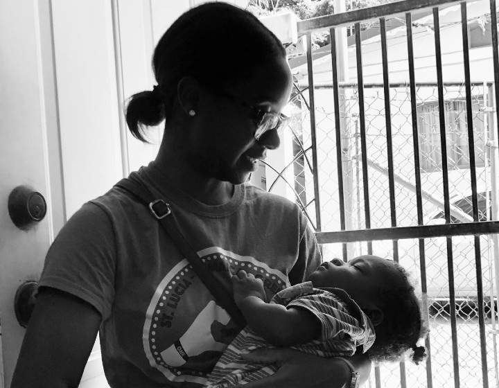 Deleon Forrester, PR manager for Sandals Grenada, holding a patient’s baby so the patient can be seen.