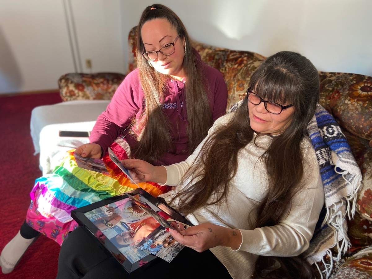 Ross Gladue's mother Noreen Gladue and his former partner Desiree Kenney look at photos of the Edmonton man who died in a homeless encampment in November 2022.