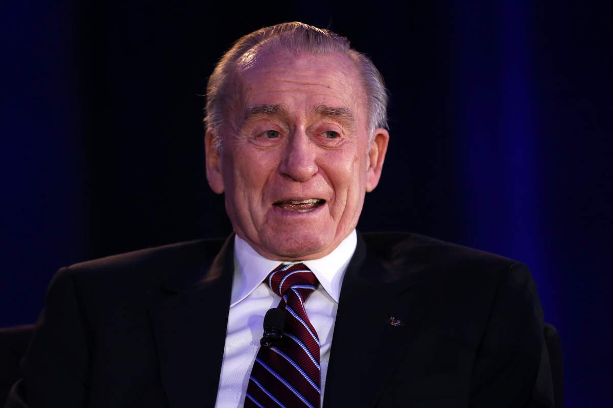 Walter Cunningham in a black suit and tie.