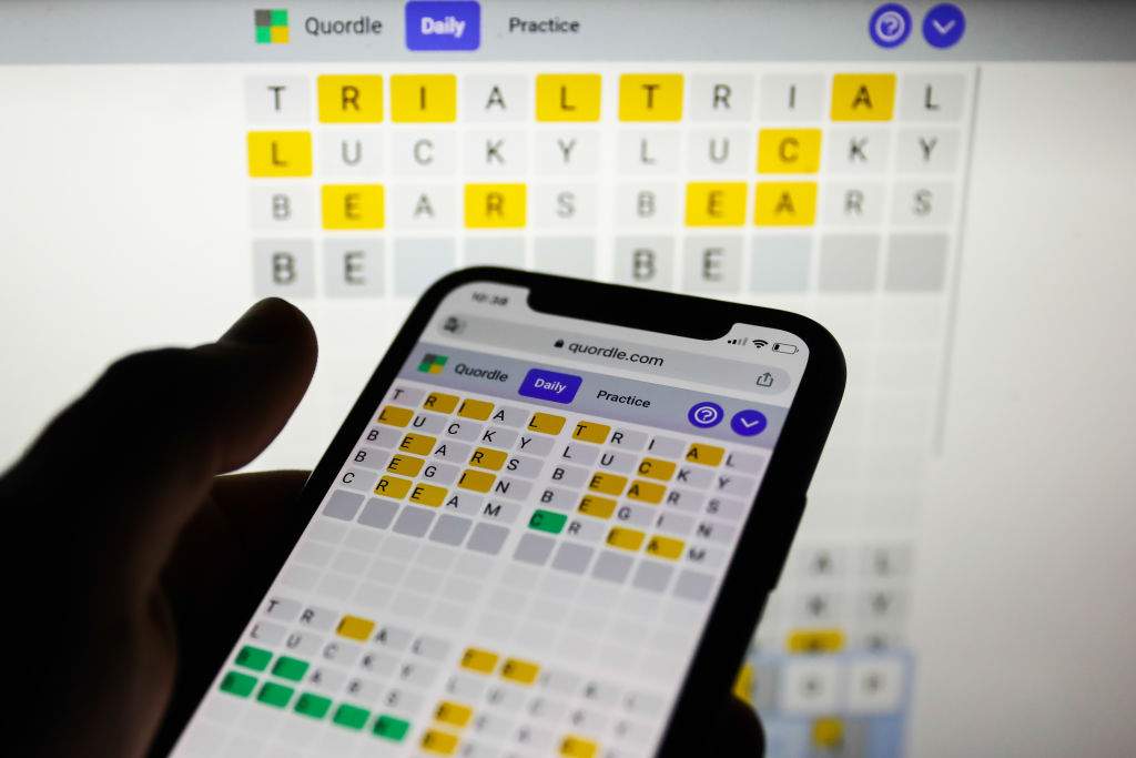 File - Quordle game displayed on a phone and a laptop screen, seen in this illustration photo taken on February 21, 2022.