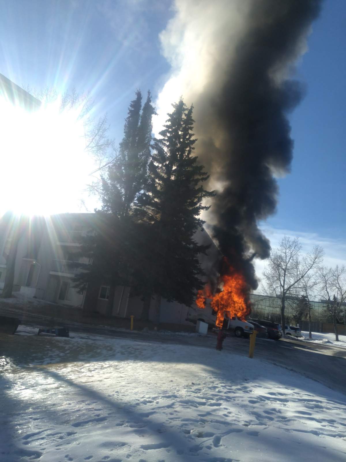 A van is seen on fire in the Albert Park/Radisson Heights neighbourhood on Jan. 11, 2023.