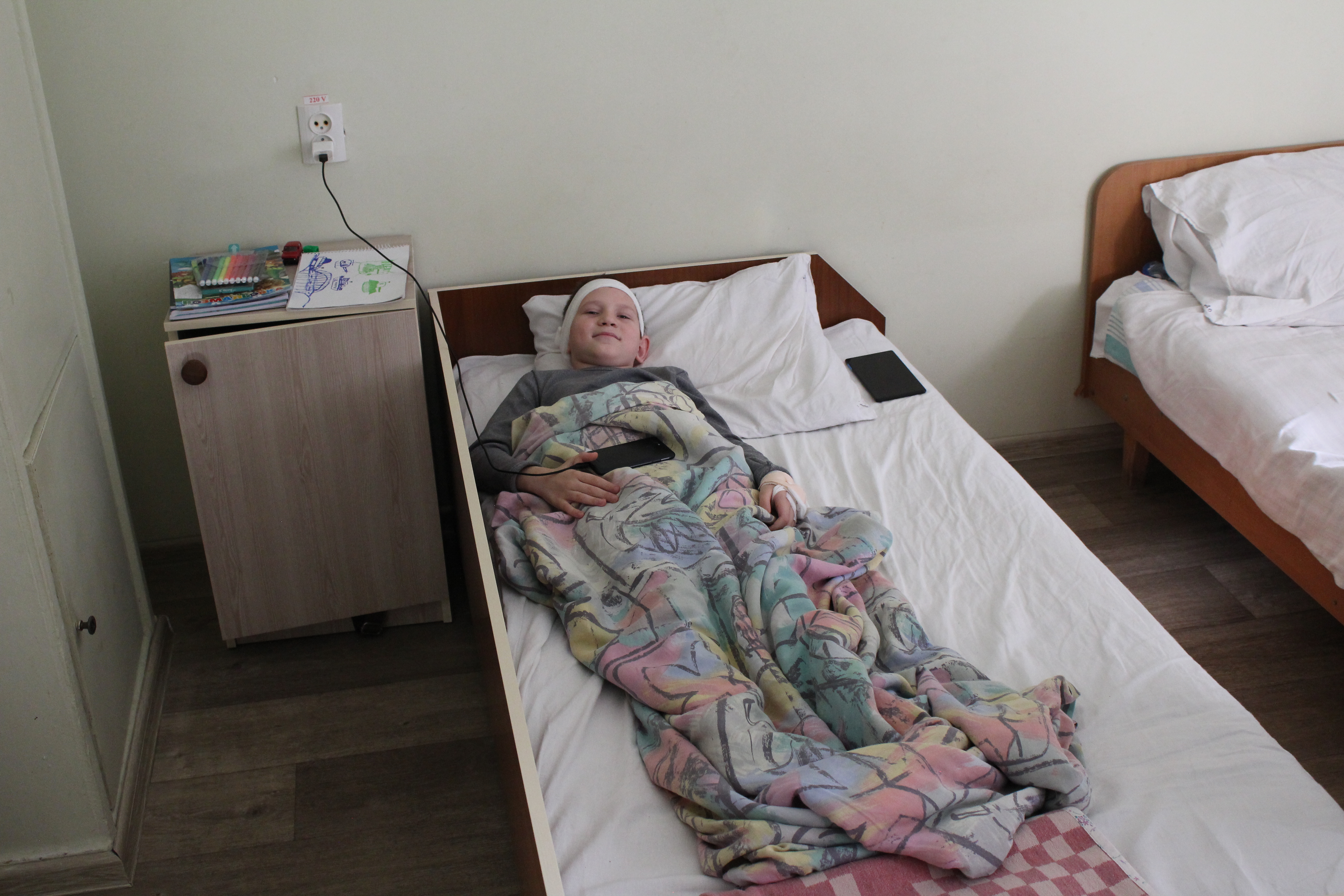 A boy recovers from surgery at Kherson children’s hospital. His mother put off treatment for his ear problem because she was afraid to leave the house to due Russian shelling.