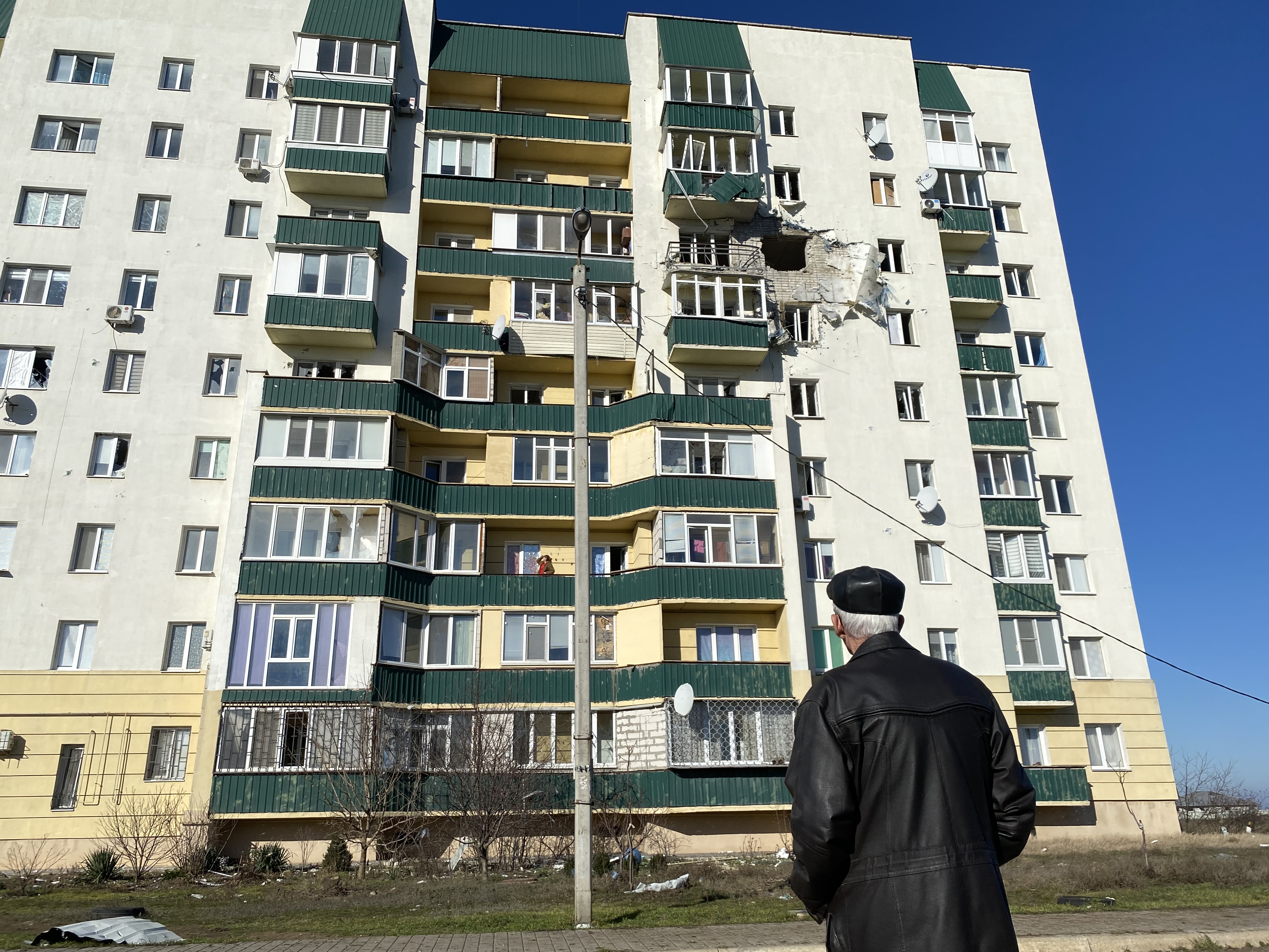 Man looks at Kherson apartment building shelled by Russians on Jan. 21, 2023.