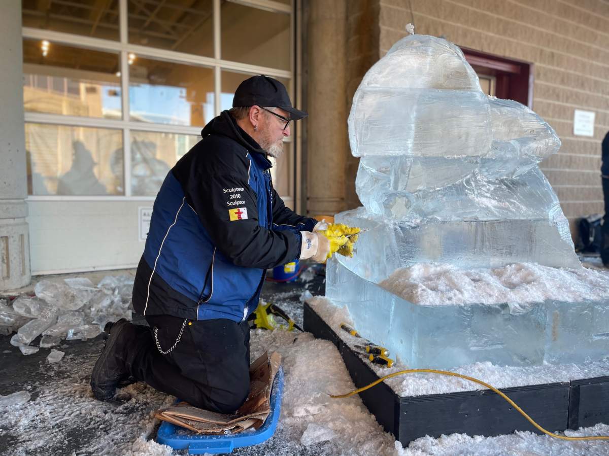 Claude Roussel carves ice at the Dartmouth Ice Festival.