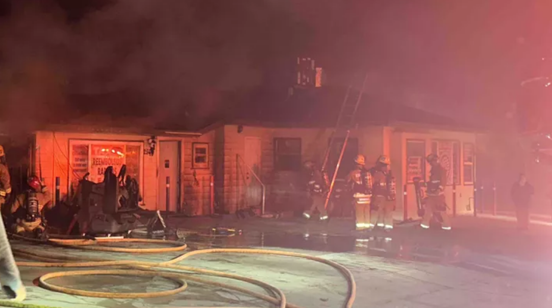 The outside of Servicio de Inmigracion in Bakersfield, California as firefighters attempt to quell flames.