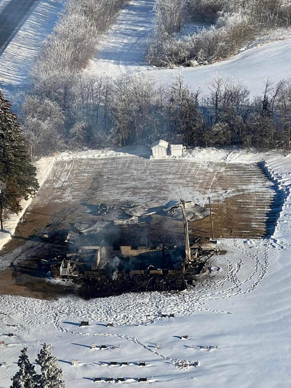An overhead photo shows a razed church in Hay Lakes, Alta.
