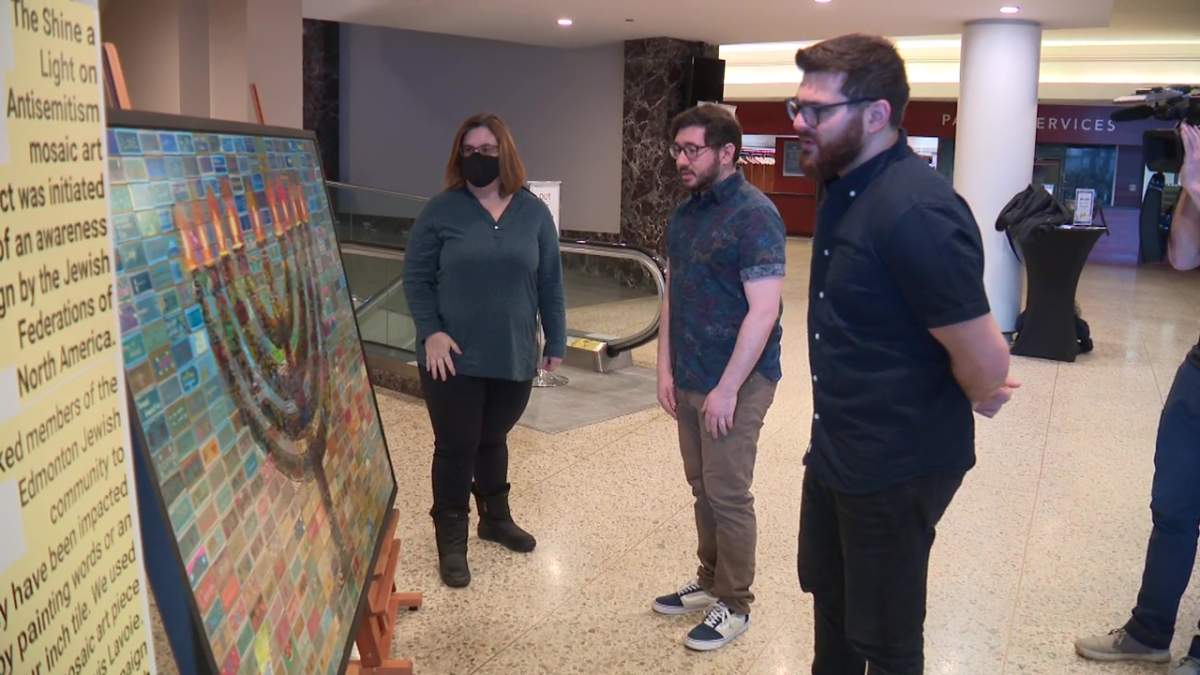 Fiddler on the Roof actors Jonathan Hashmonay and Elliot Lazar look at the "Shine A Light on Antisemitism" art piece on display at the Northern Alberta Jubilee Auditorium in Edmonton, Alta. on Wednesday, Jan. 4, 2023.