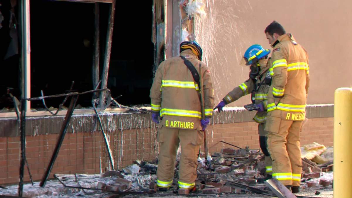 Investigators comb through evidence of a fire at a Calgary restaurant on Jan. 5, 2023.