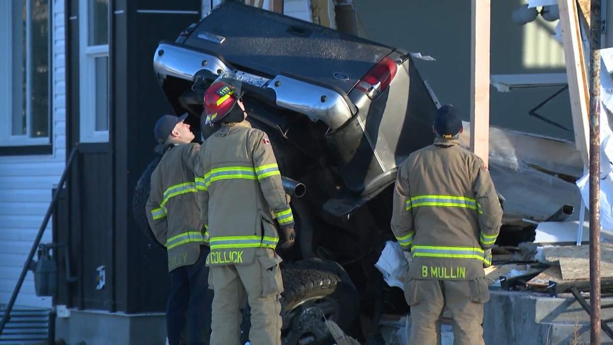 Calgary firefighters assess the damage after a truck had crashed into a home in Ogden the morning of Jan. 6, 2023.