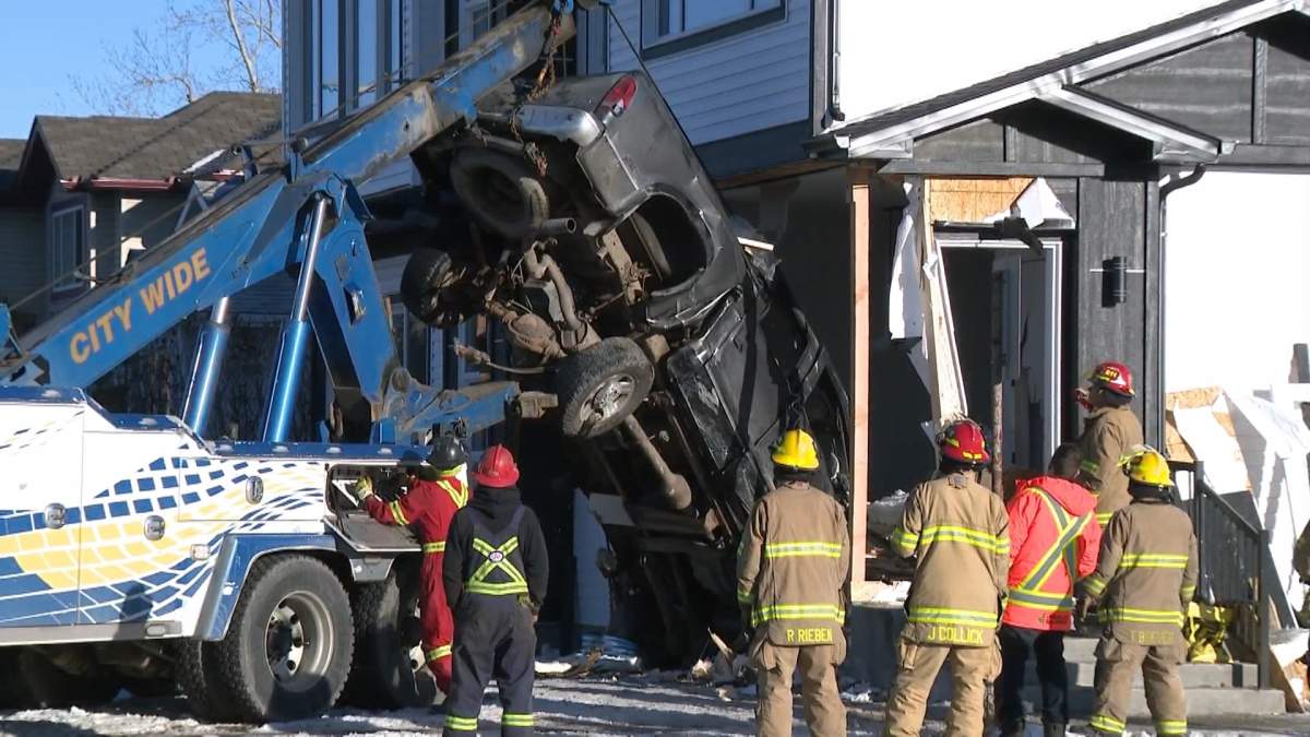 A tow truck pulls out the truck that had crashed into an Ogden home on Jan. 6, 2023.