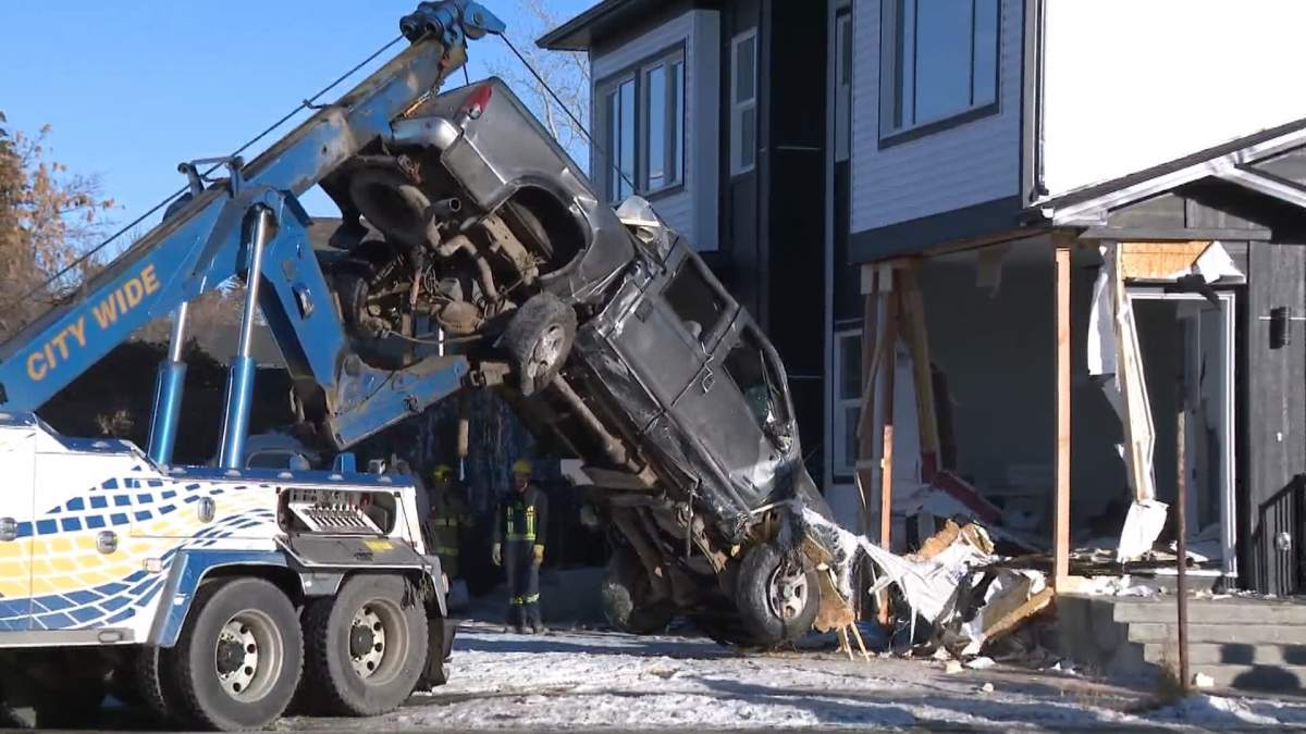 Around 11 a.m. a tow truck pulls out the truck that had crashed into an Ogden home on Jan. 6, 2023.