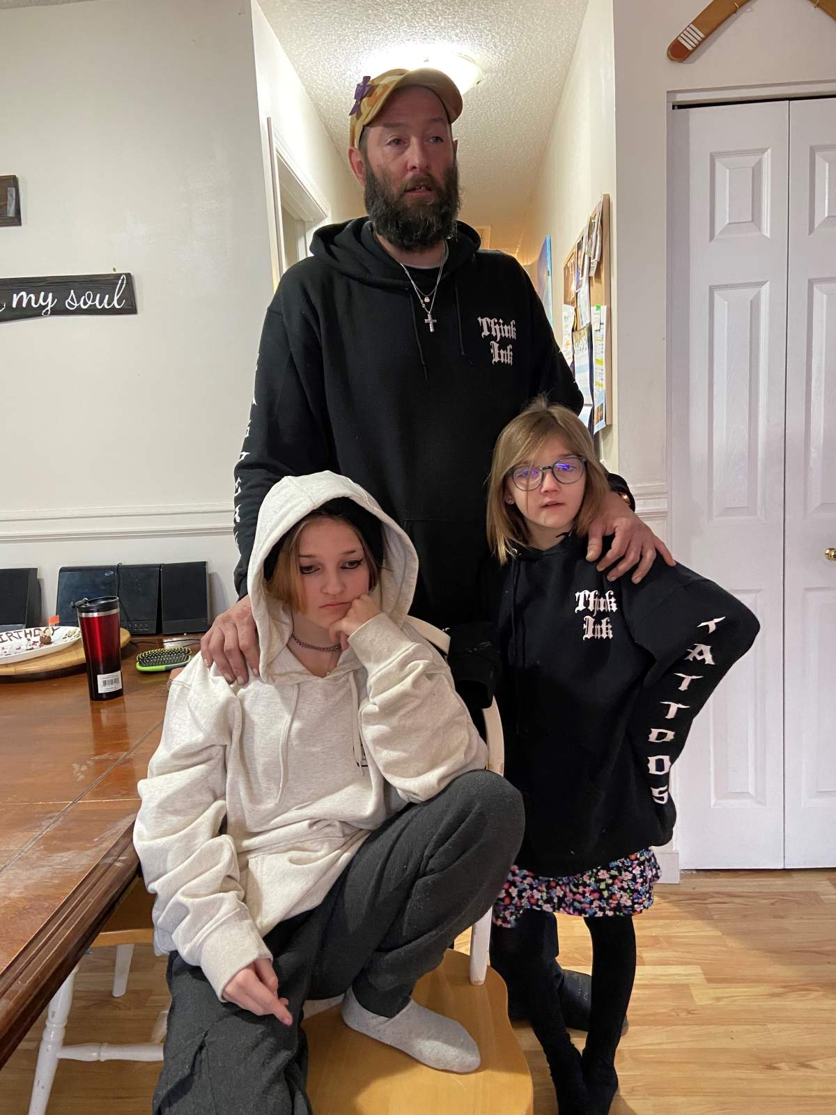 Jeff Poirier (centre) with 14-year-old Caera and 9-year-old Arianna Shaw, daughters of Angela McKenzie who died following a car crash on May 10, 2022.