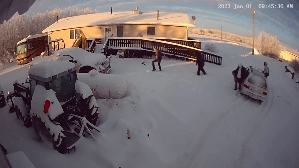 Four men seen leaving the vehicle and walking towards a home near Redwater, Alta. before breaking in.