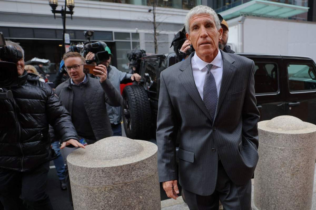 William Singer outside the courthouse in a suit.
