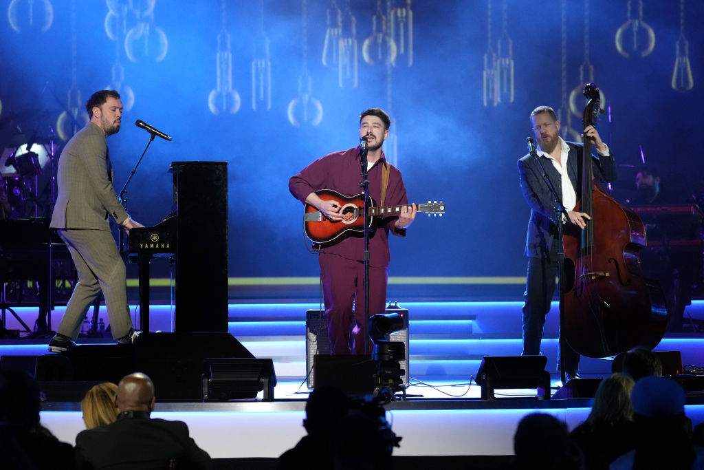 Mumford and Sons performing live on stage.