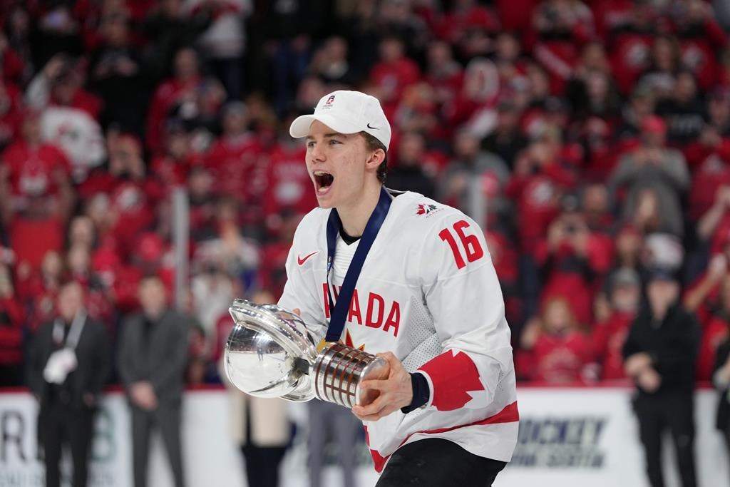 Canada’s Connor Bedard carries the IIHF Championship Cup while celebrating winning over Czechia at the IIHF World Junior Hockey Championship gold medal game. THE CANADIAN PRESS/Darren Calabrese