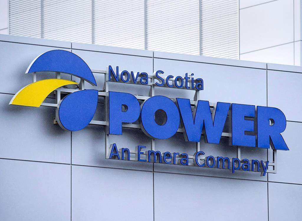 A blue sign on a grey tiled building that reads 'Nova Scotia Power an Emera Company'.