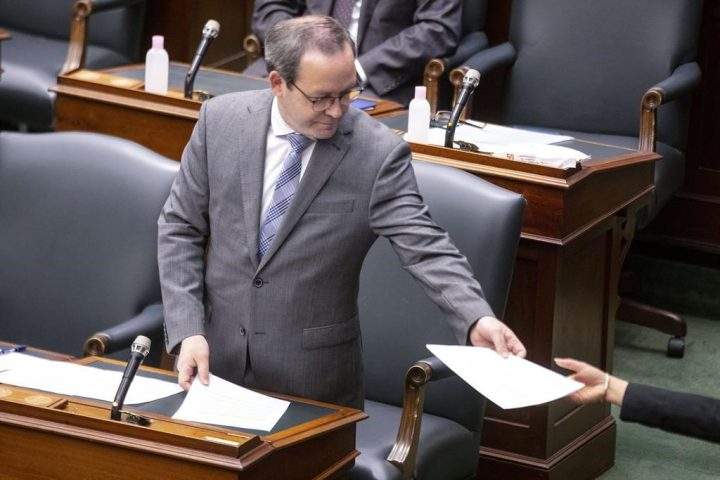 Ontario Attorney General Doug Downey hands over paperwork to a page in the Queens Park Legislature, in Toronto, on Thursday June 10, 2021. Indigenous leaders and the province have opened a centre in northwest Ontario in an effort to address the overrepresentation of Indigenous people in the justice system.