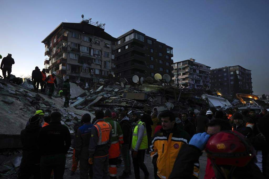 Rescue teams search for people in the rubble of destroyed buildings in Antakya, southern Turkey, Wednesday, Feb. 8, 2023.