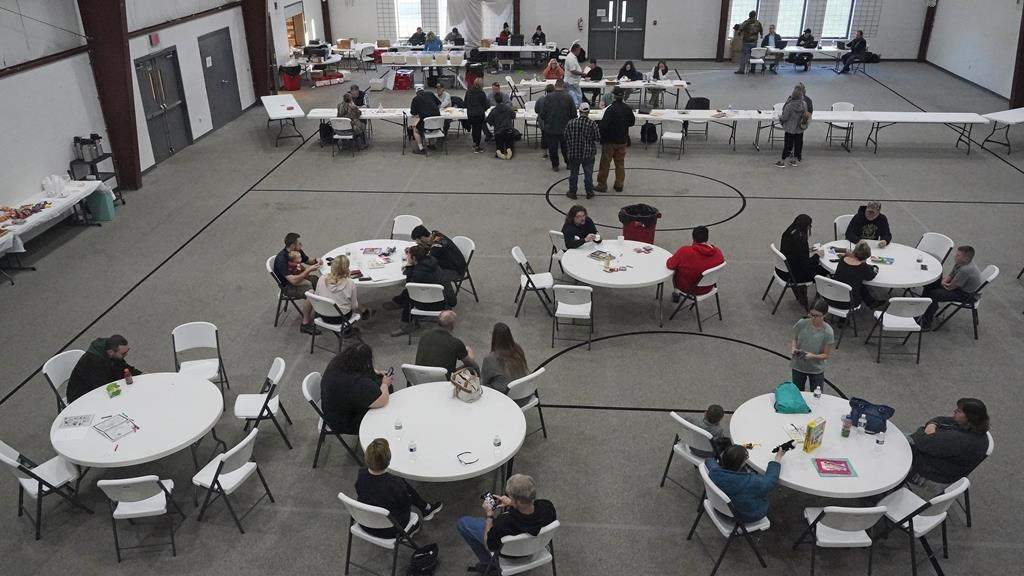 People gather at the Norfolk Southern Railways Assistance Center Thursday, Feb. 9, 2013, at the Abundant Life Fellowship in East Palestine, Ohio.