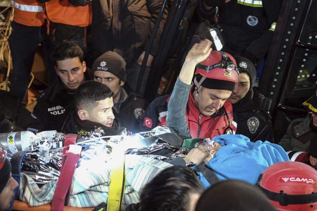 Rescuers surround Hatice after she was rescued 92 hours after Monday’s earthquake in Kahramanmaras, southern Turkey, early Friday, Feb. 10, 2023. Hatice waved and smiled until she got into an ambulance.