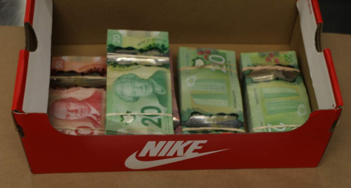 Cash seized as part of a drug trafficking investigation by Edmonton police, Feb. 2023.