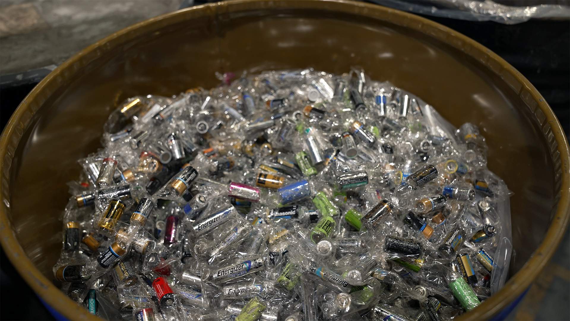Inside barrels at Li-Cycle's Kingston plant are retired consumer batteries wrapped in plastic. These batteries help to supplement battery supply while recyclers wait for more EV batteries to come off the road.
