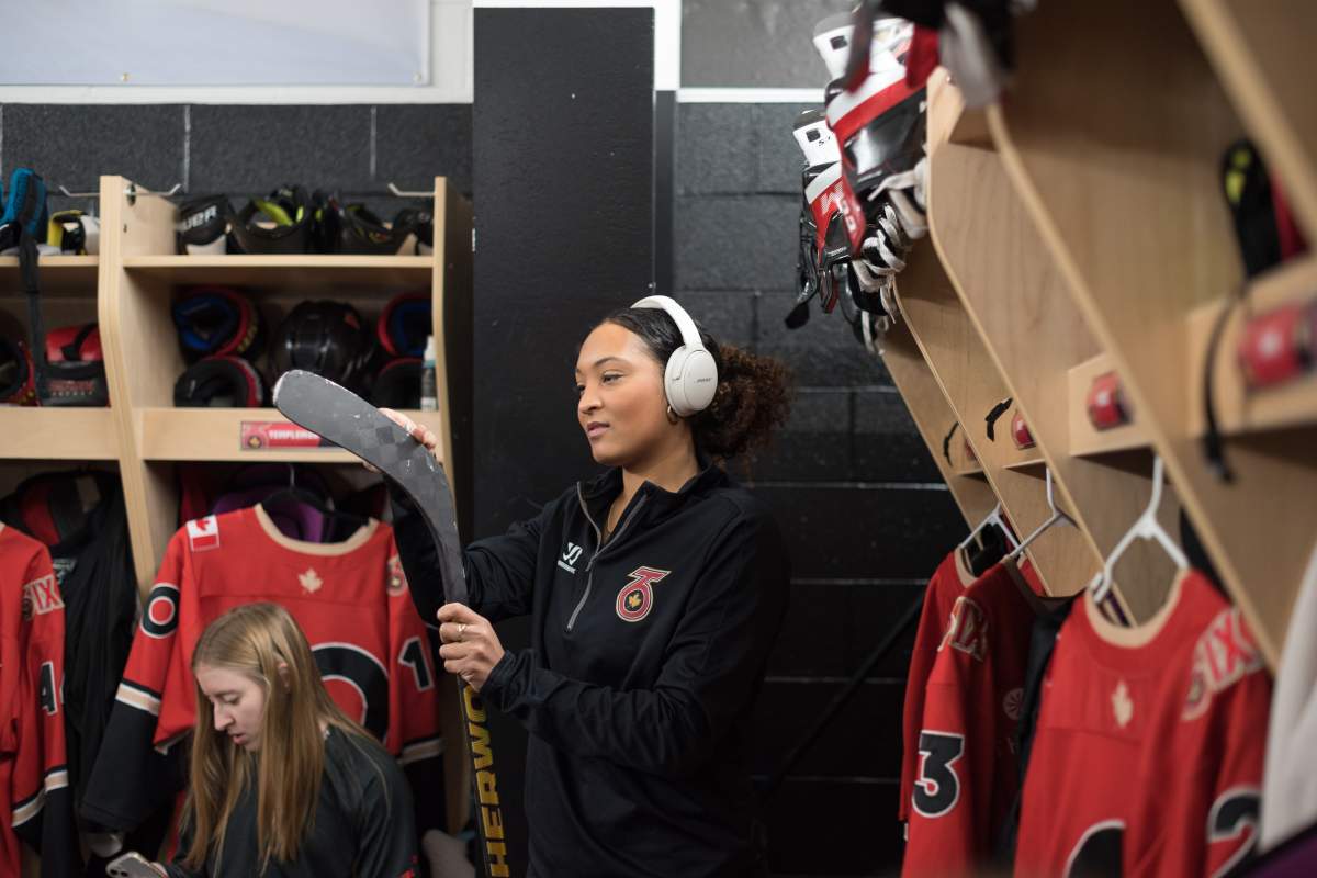 Saroya Tinker of the Toronto Six of the Premier Hockey Federation listens to music while prepping her stick before a home game against the Connecticut Whale, at Canlan Sports at York University in Toronto, on Saturday, January 21, 2023. THE CANADIAN PRESS/ Tijana Martin