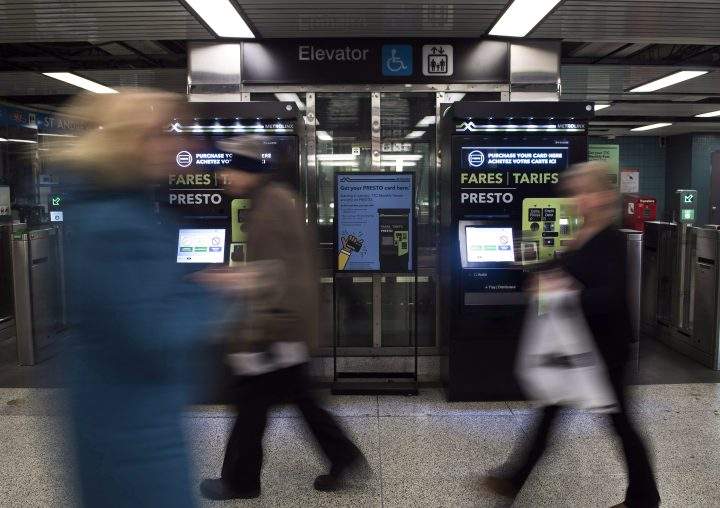 People walk past Presto machines underground in the TTC subway portals in Toronto on Dec. 4, 2018. 