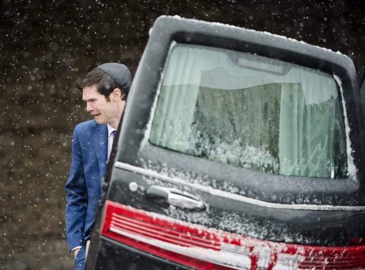 A man cries after placing the casket inside the hearse at the funeral for four-year-old Keira Kagan in Toronto on Thursday, February 13, 2020.