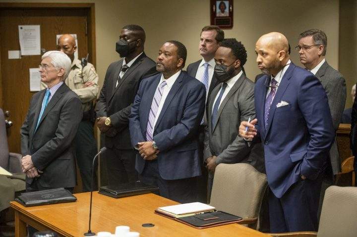 Men including lawyers and those accused in the death of Tyre Nichols stand at a table in a court room