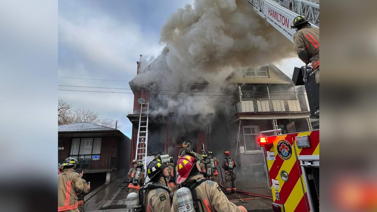 Firefighters battle a blaze at a residential home on Century Street in Hamilton Feb 17, 2023.
