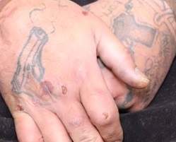Tattoos on the hands of Edmonton homicide suspect Donn Austin Gauthier.