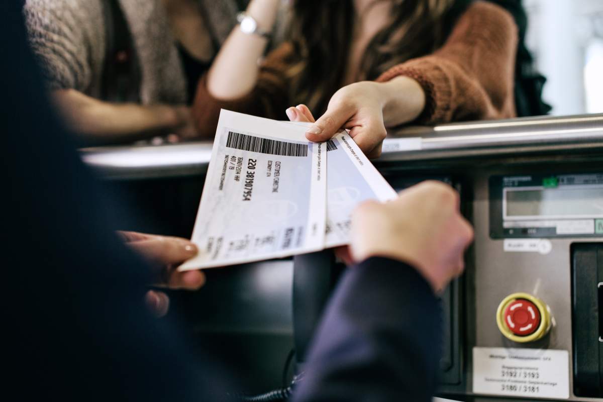 Plane tickets are handed off to a clerk.