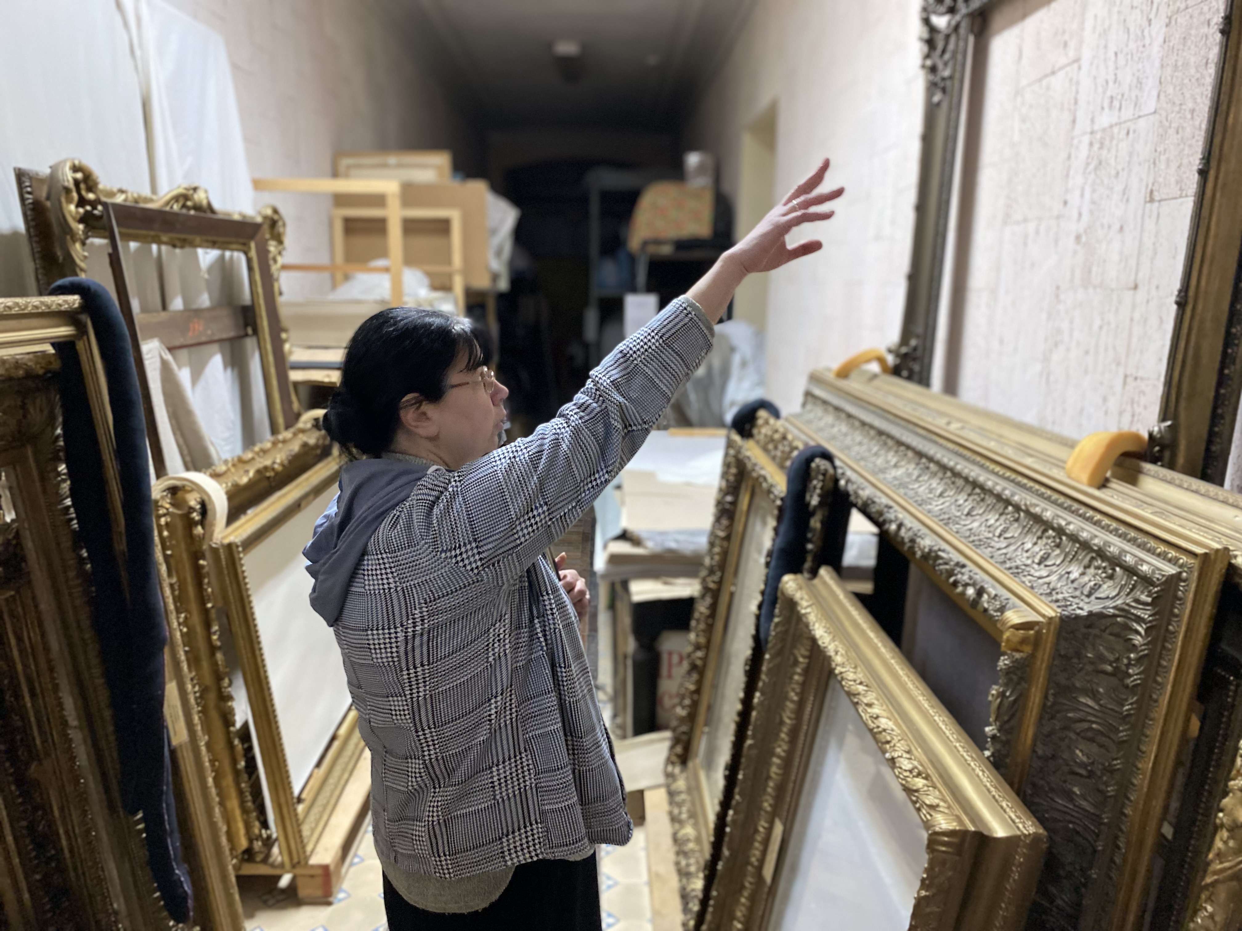 Hanna Skrypka, deputy director of the Kherson art museum, shows frames of paintings looted by Russians, Jan. 19, 2023.