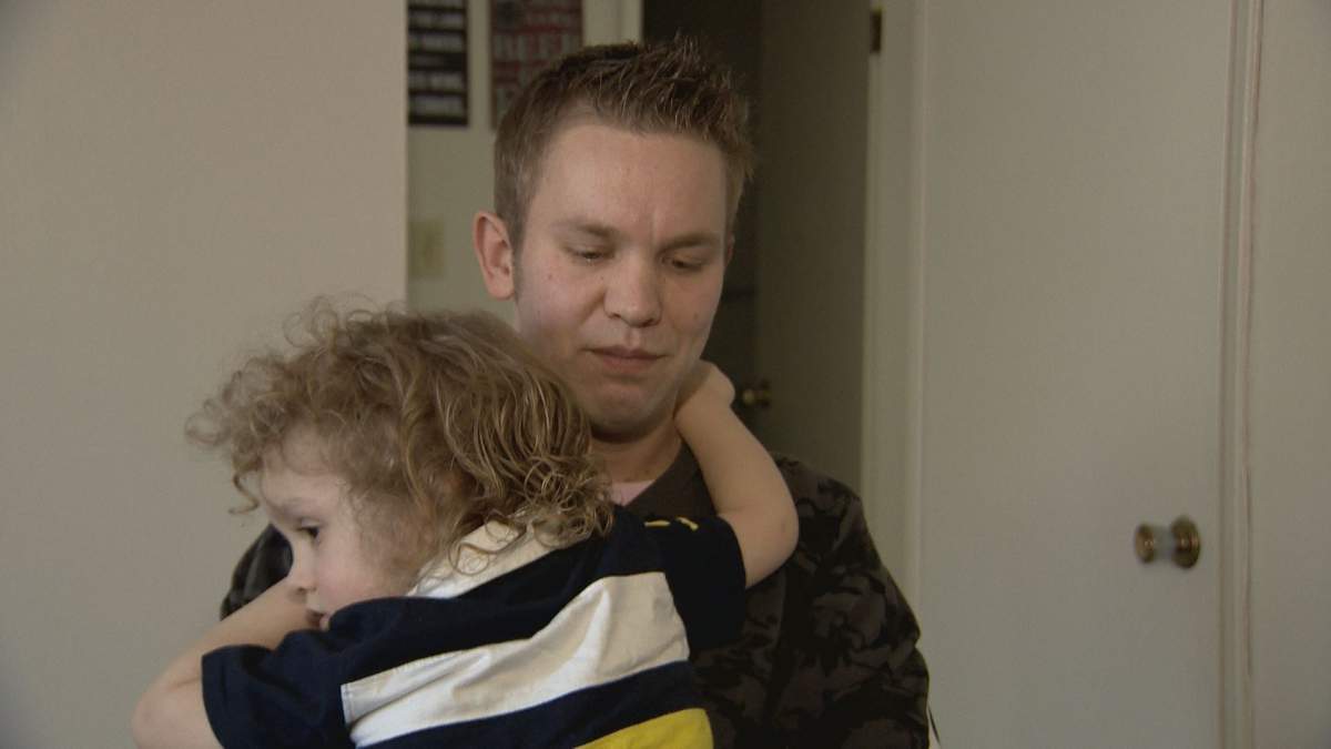 James Antell holds his son.