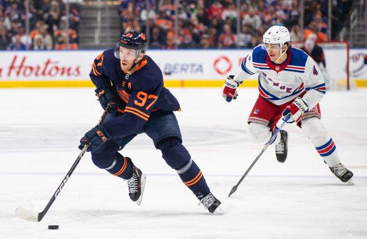 New York Rangers’ Braden Schneider (4) chases Edmonton Oilers’ Connor McDavid (97) during second period NHL action in Edmonton on Friday February 17, 2023.