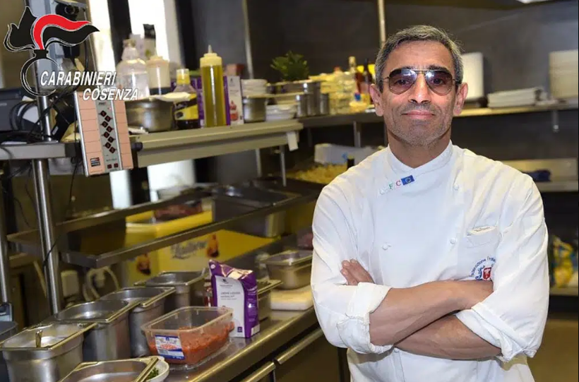 Edgardo Greco in a chef's coat, standing in a kitchen.