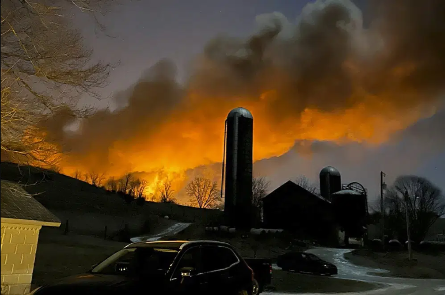 In this photo provided by Melissa Smith, a train fire is seen from her farm in East Palestine, Ohio, Friday, Feb. 3, 2023.