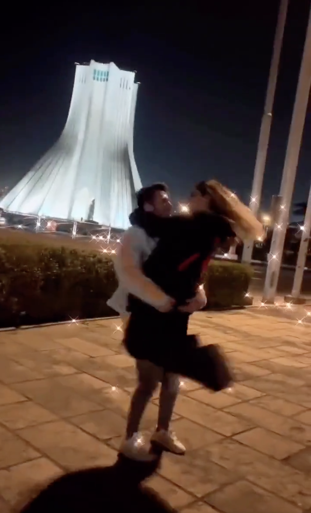 Screenshot of a viral video showing a young couple dancing in front of Iran’s Azadi Tower.