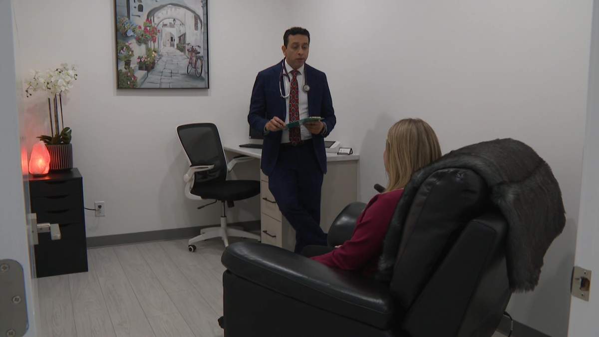 Ketamine treatment patient Cassandra Walker speaking with Dr. Yogesh Thakker, a psychiatrist and owner of Manor Clinic, in south Edmonton on Wednesday, Feb. 22, 2023.