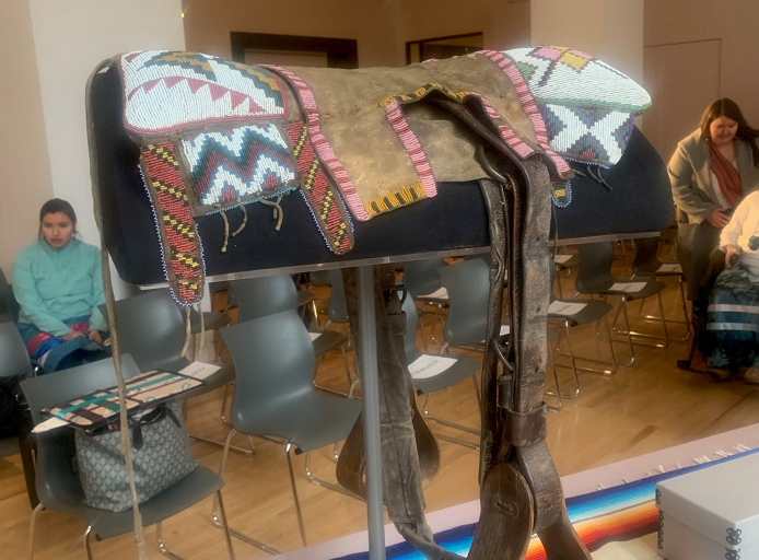 The ROM is transferring a pipe and a saddle that belonged to Chief Poundmaker back to members of his family.