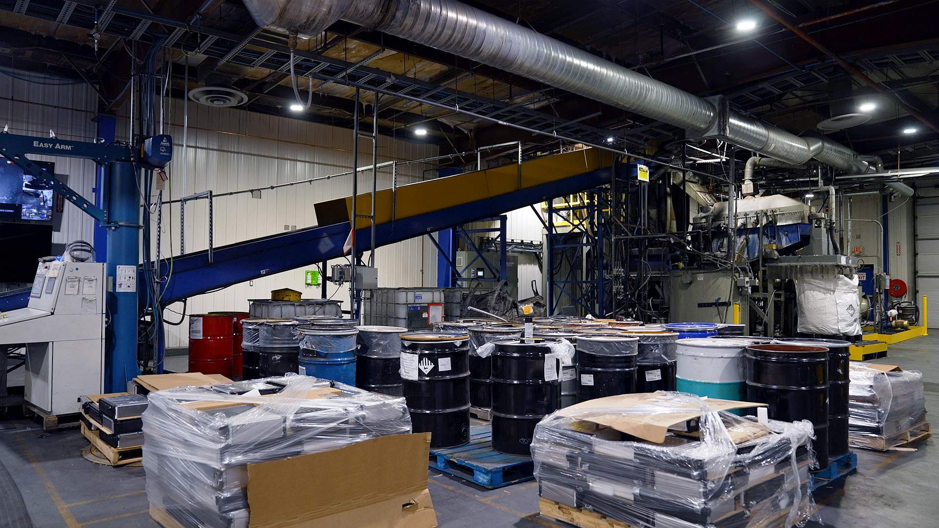 Barrels and skids of batteries wait to be shredded and broken down.