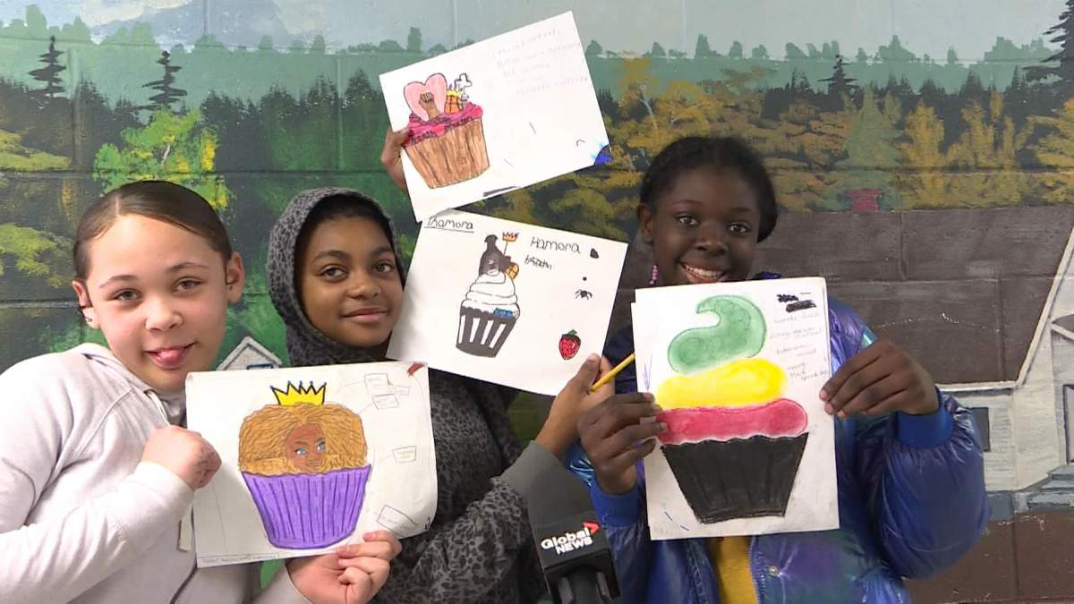 Students Keneshia Bright, Kamora Cain and Anasia Downey show off their cupcake designs.