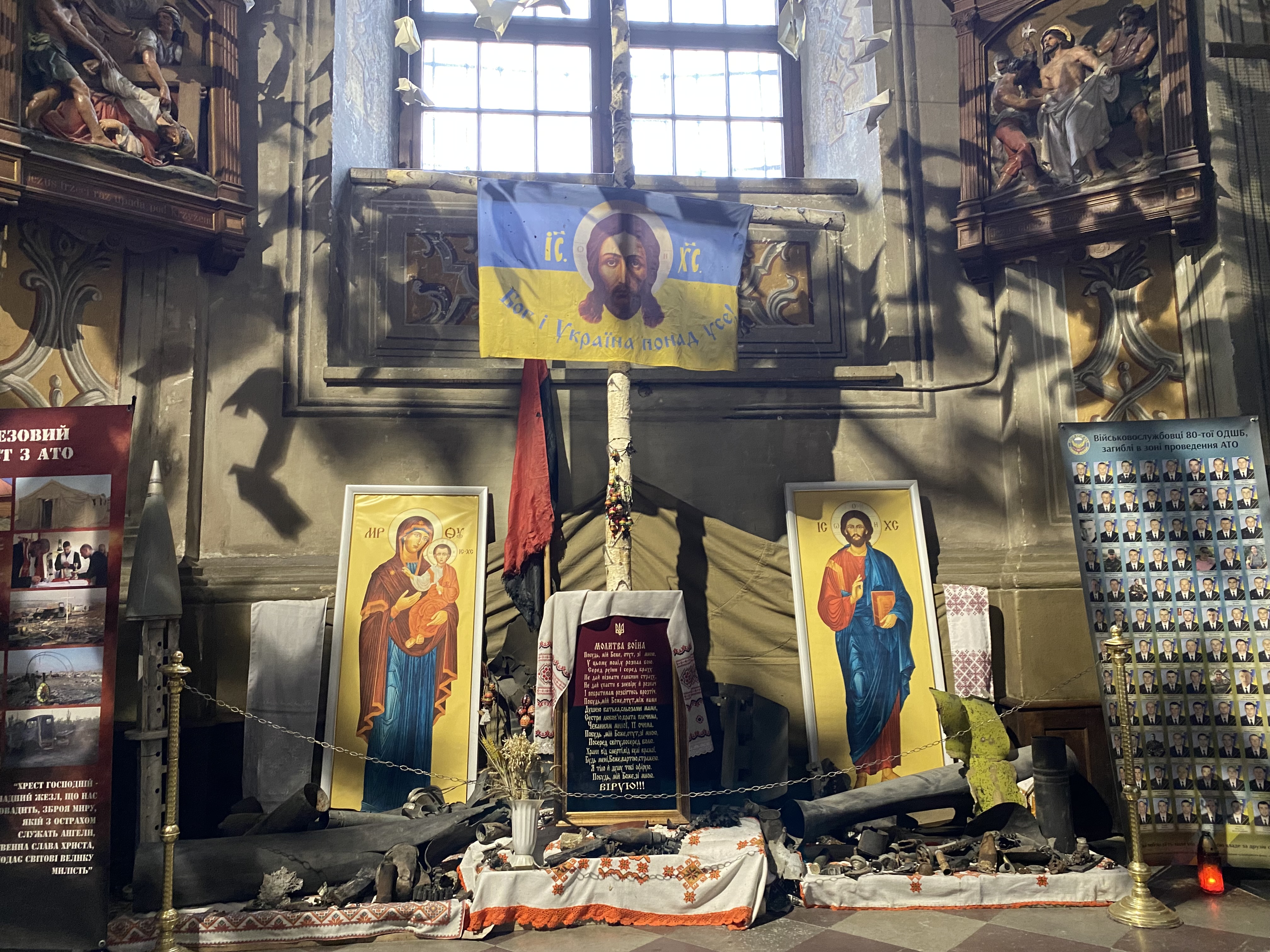 Photos of fallen soldiers and a display of war debris in the garrison church in Lviv, Ukraine, Jan. 16, 2023.