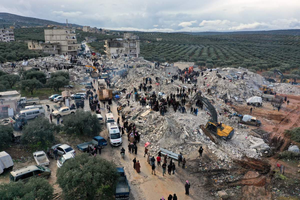 Civil defence workers search the rubble of buildings in Syria folowing the earthquake.
