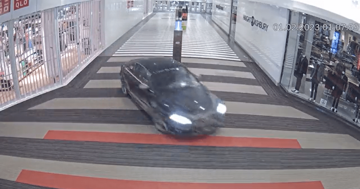 Surveillance video screenshot of a black 2011 Audi A4 driving through Vaughan Mills mall on Wednesday, Feb. 1, 2023 in an overnight break-and-enter.