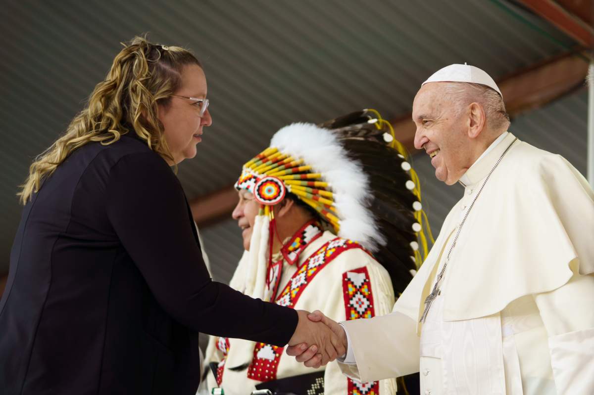 Assembly of First Nations Manitoba Regional Chief Cindy Woodhouse shakes hands with Pope Francis visits in Maskwacis, Alta. on July 24, 2022.