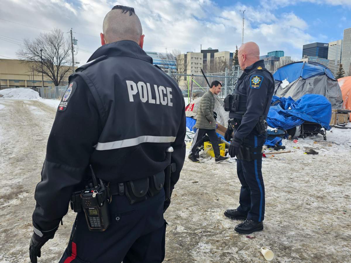 An Alberta Sheriff and Edmonton Police Service officer near a homeless encampment north of downtown Edmonton, Alta. on Thursday, March 2, 2023.